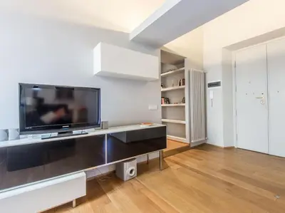 a living room with a large flat screen tv at Luxury Fori Imperiali Flat in Rome