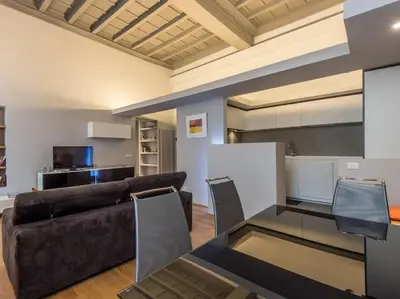a living room with a couch and a table at Luxury Fori Imperiali Flat in Rome