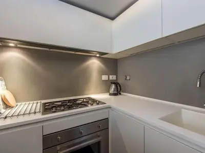 a kitchen with a stove top oven next to a sink at Luxury Fori Imperiali Flat in Rome
