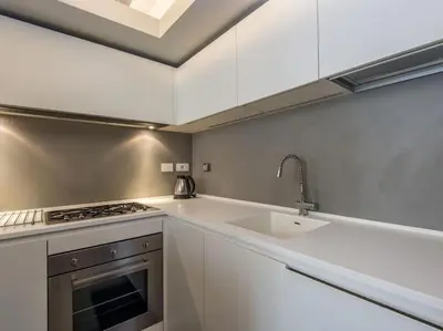 a kitchen with a sink and a stove at Luxury Fori Imperiali Flat in Rome