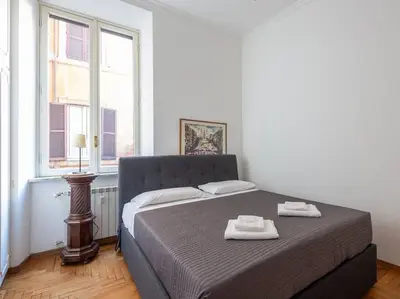 a bedroom with a bed with two towels on it at Giulia Luxury Two Bedroom Apartment in Rome