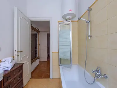 a bathroom with a shower and a sink and a mirror at Giulia Luxury Two Bedroom Apartment in Rome