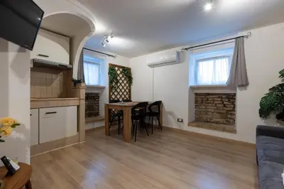 a kitchen and living room with a table and chairs at Arya Roma Vaticano in Rome