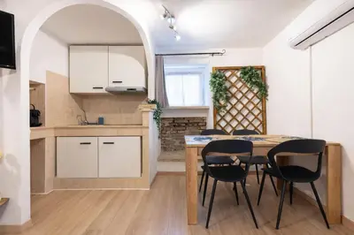 a kitchen and dining room with a table and chairs at Arya Roma Vaticano in Rome