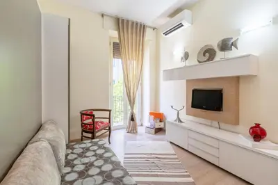 a living room with a couch and a tv at Appartamento Celio in Rome