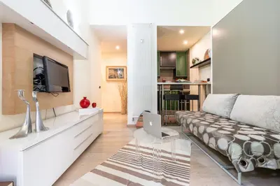 a living room with a couch and a tv at Appartamento Celio in Rome
