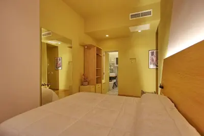 a bedroom with a large bed in a room at Dreaming Rome Suites in Rome