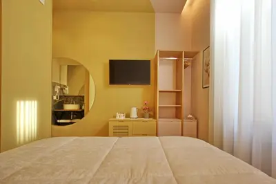 a bedroom with a bed and a tv on the wall at Dreaming Rome Suites in Rome