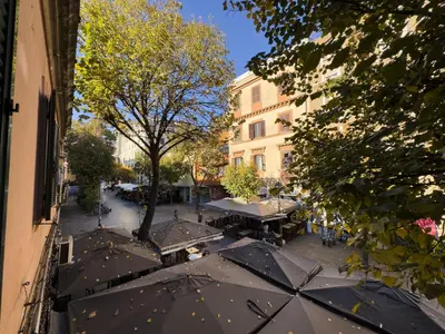 an overhead view of a street with tables and umbrellas at Vintage and Design in the Heart of Vibrant Pigneto in Rome