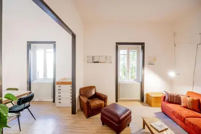 a living room with a couch and a chair at Vintage and Design in the Heart of Vibrant Pigneto in Rome
