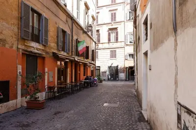 an empty alley with a flag on a building at Navona 360 in Rome