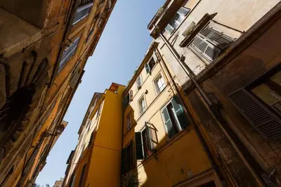 a yellow building in the middle of two buildings at Navona 360 in Rome