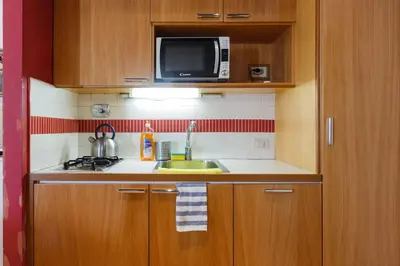 a small kitchen with a sink and a microwave at Navona 360 in Rome