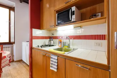a small kitchen with a sink and a microwave at Navona 360 in Rome