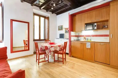 a kitchen and dining room with a table and chairs at Navona 360 in Rome