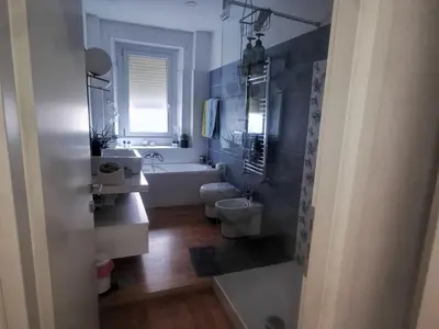 a bathroom with a tub and a toilet and a sink at La verde dimora in Rome