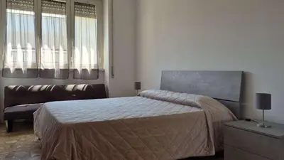 a bedroom with a bed and a couch at Camera matrimoniale vicino a San Pietro in Rome
