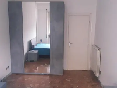 a mirror in a room with a bed in it at Camera matrimoniale vicino a San Pietro in Rome