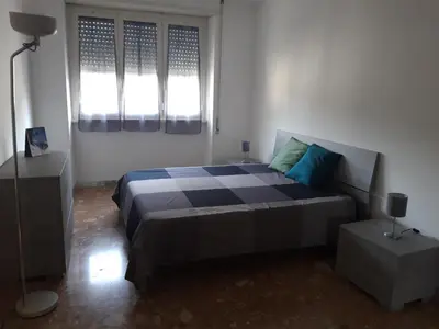 a bedroom with a bed and two windows at Camera matrimoniale vicino a San Pietro in Rome