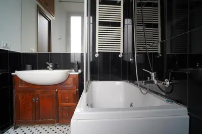 a bathroom with a sink and a bath tub and a sink at La Casa Romana in Rome