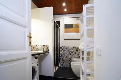 a bathroom with a toilet and a sink at La Casa Romana in Rome