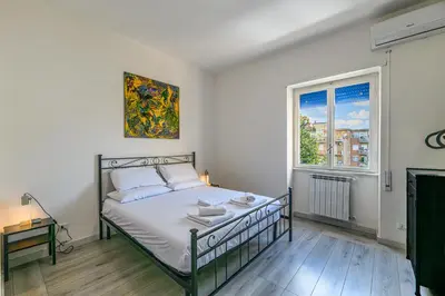 a bedroom with a bed and a window at AmoRoma Holiday in Rome