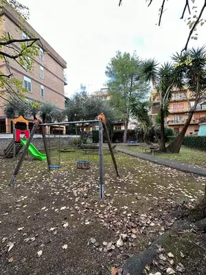 a playground with a swing set in a park at AmoRoma Holiday in Rome