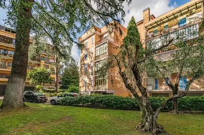an apartment building with cars parked in front of it at AmoRoma Holiday in Rome