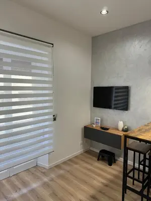 a room with a sliding door with a desk and a television at Maddalena Means Home in Rome