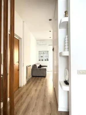 a hallway with a couch in a white room at Maddalena Means Home in Rome