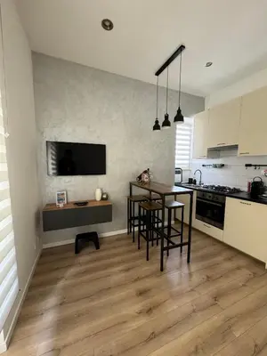 a kitchen with a table and some chairs in a room at Maddalena Means Home in Rome