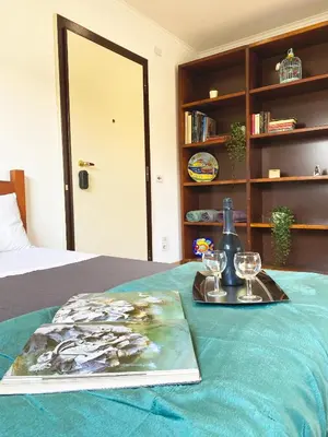 a table with a tray of wine glasses and a book at Bright Penthouse 2 M stops from Vatican Museums in Rome