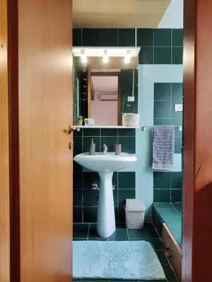 a bathroom with a sink and a mirror at Bright Penthouse 2 M stops from Vatican Museums in Rome