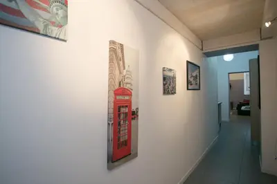a wall with a red phone booth painting on a wall at Alloggio Turistico Cadorna - Fontana di Trevi , Via Veneto Piazza di Spagna in Rome