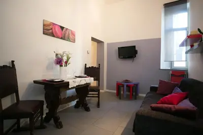 a living room with a table and a couch at Alloggio Turistico Cadorna - Fontana di Trevi , Via Veneto Piazza di Spagna in Rome