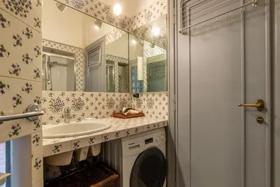 a bathroom with a sink and a mirror at GuestHost - MM Re di Roma Apartment in Rome