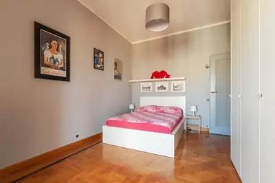 a bedroom with a bed with a red mattress at GuestHost - MM Re di Roma Apartment in Rome
