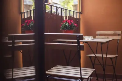 a table and chairs with flowers on a balcony at Dolce Casa in San Pietro in Rome