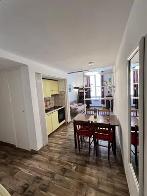 a kitchen and dining room with a table and chairs at Dolce Casa in San Pietro in Rome
