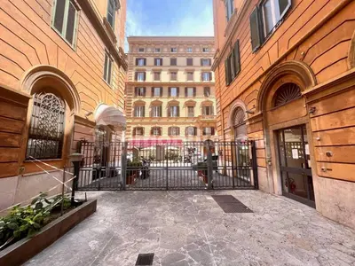 a building with a gate in the middle of a courtyard at Apartment Roma Centro San Pietro e Musei Vaticani in Rome