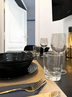 a table with a plate and glasses on a table at TP Apartment Luxury Colosseum in Rome