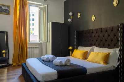 a bedroom with a bed with two towels on it at TP Apartment Luxury Colosseum in Rome