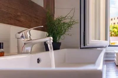a white sink with a faucet and a window at TP Apartment Luxury Colosseum in Rome