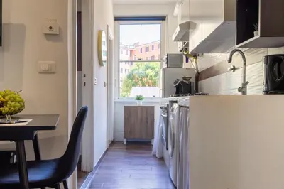 a kitchen with a counter and a table and a window at TP Apartment Luxury Colosseum in Rome