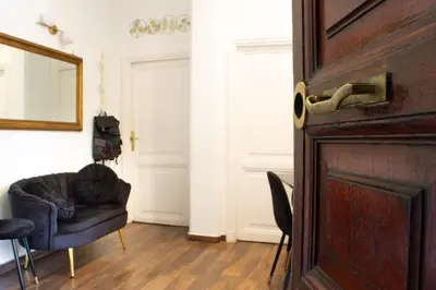 a room with a door with a chair and a mirror at TP Apartment Luxury Colosseum in Rome