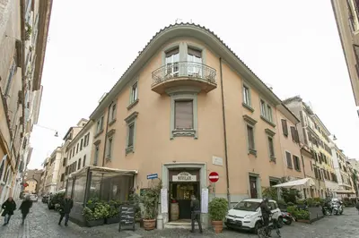 a building with a balcony on the side of a street at Borgo Vittorio 20 Vatican Home in Rome