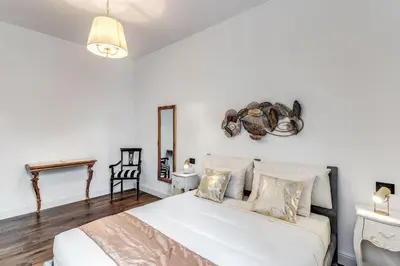 a bedroom with a white bed and a mirror at RIPETTA234 in Rome