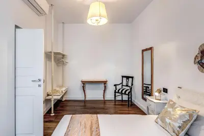 a bedroom with a bed and a mirror and a table at RIPETTA234 in Rome