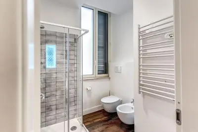 a bathroom with a toilet and a glass shower at RIPETTA234 in Rome