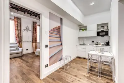 a kitchen with white cabinets and a staircase in a room at RIPETTA234 in Rome